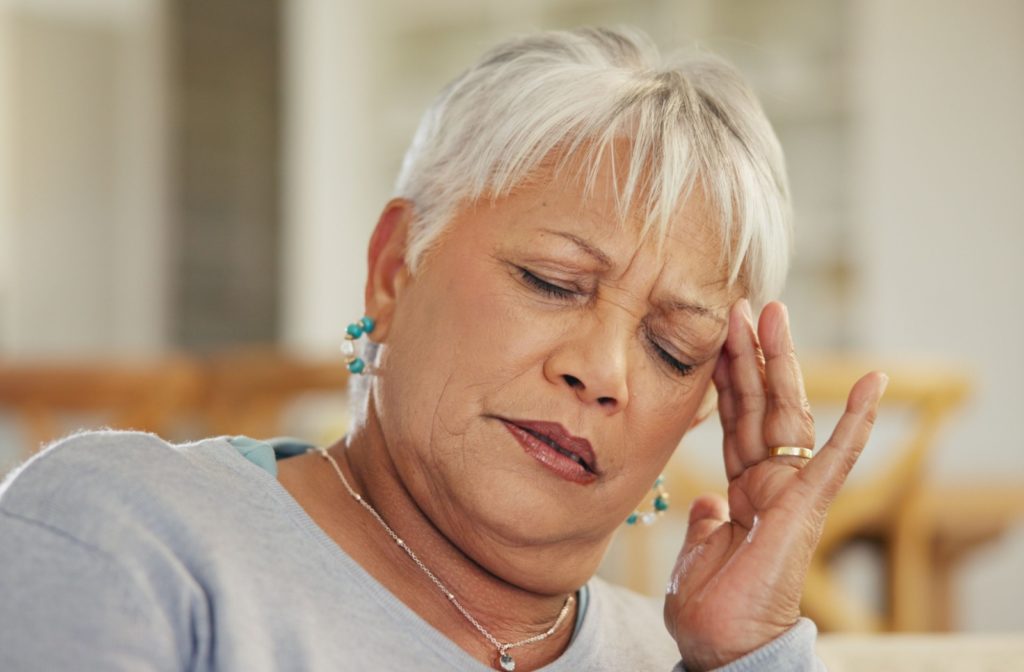 Senior woman showing signs of brain fog, looking fatigued.