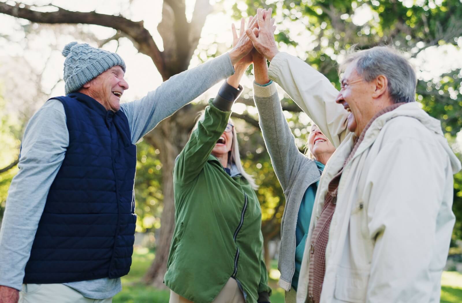 A group of seniors spend time together in the park, doing some outdoor activities.