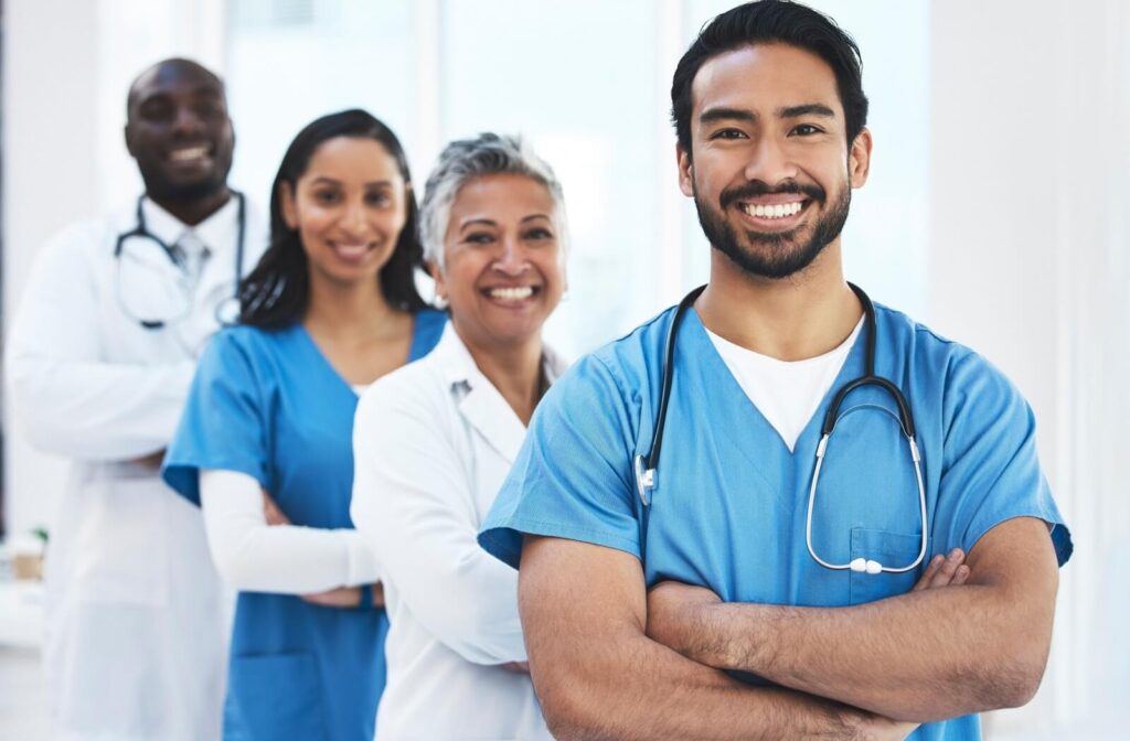 A group of nurses stand together, proud to provide care for seniors in memory care with various stages of dementia