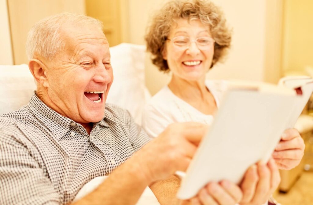 Seniors smiling and laughing while playing a trivia game together in a book